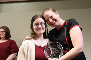 Adrienne and a student standing together with Adrienne's award.