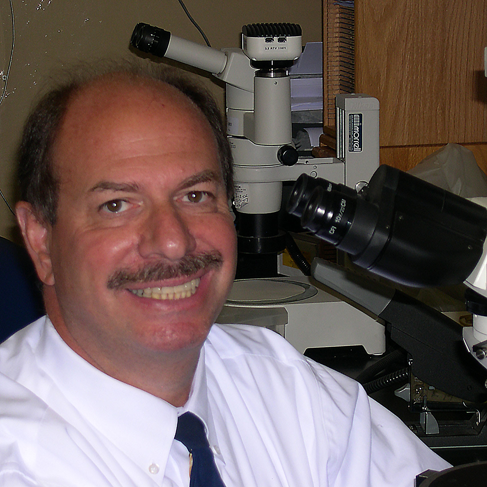Scott Kovar in front of microscope