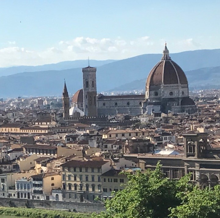 A picture of a view of Florence Italy featuring a church.